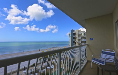 Balcony view, patio in the foreground with the beach and Gulf of Mexico in the background.