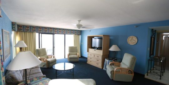 living room with three recliners, tv, and sofa