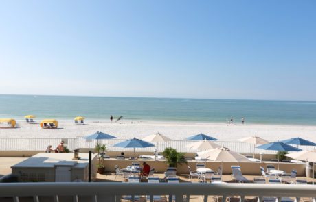 Balcony view, patio in the foreground with the beach and Gulf of Mexico in the background.