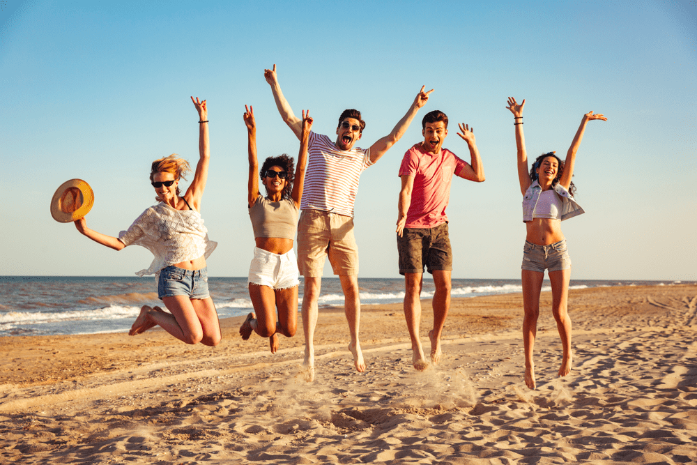 Group of friends jump on Madeira Beach.