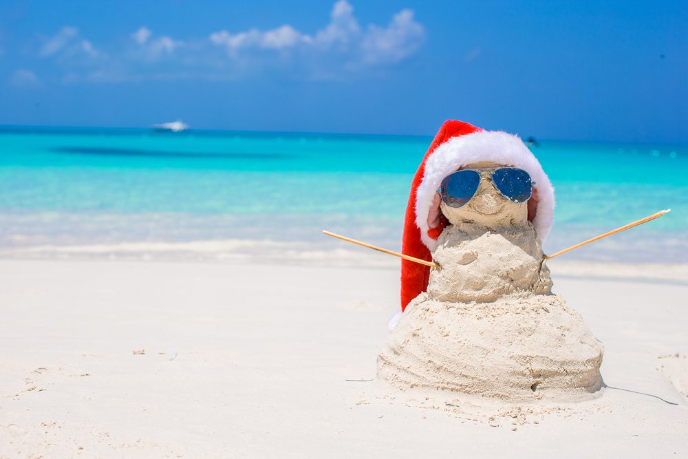 A sandman (or snowman made of sand) wears sunglasses on the beach during the holiday season in Madeira Beach.