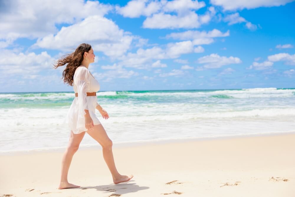 A woman enjoying a walkable beach area