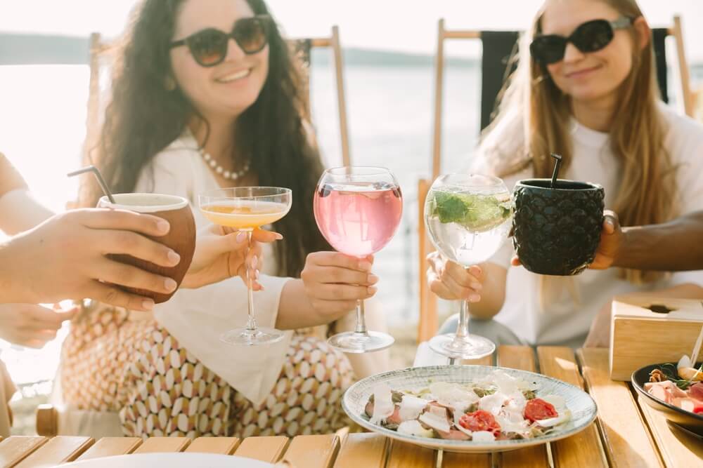 Friends enjoying a waterfront restaurant near Shoreline Island Resort.