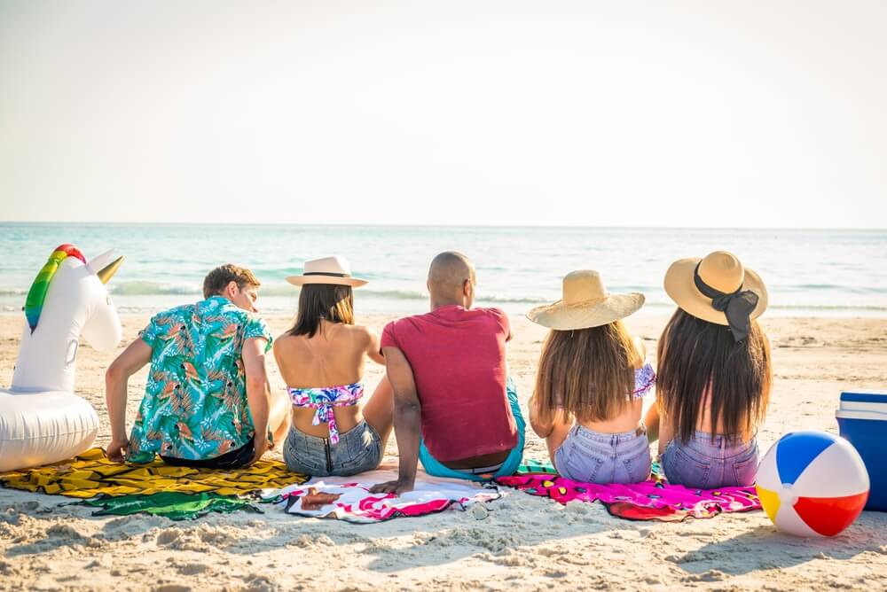 Guide to Beach Access Points in Madeira Beach: A group of friends sitting together on the beach